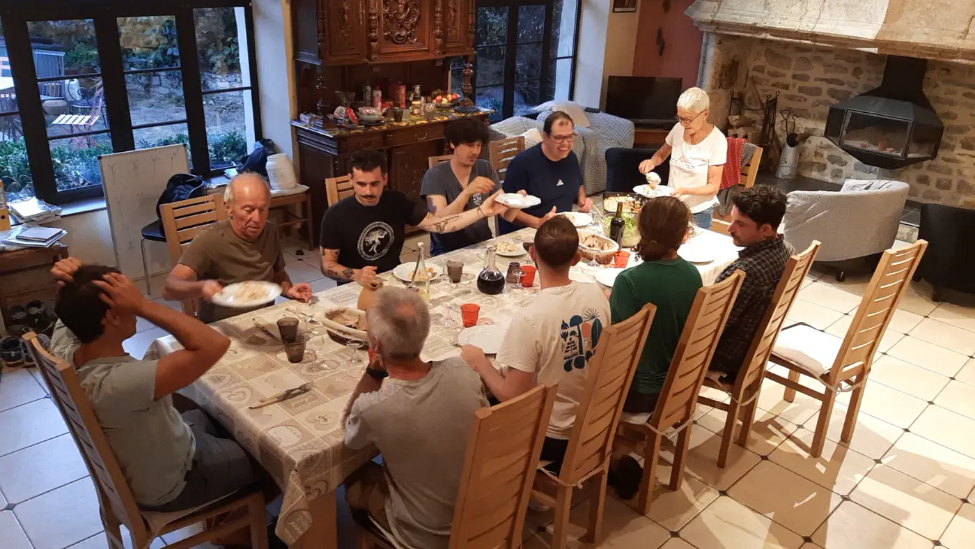 L’équipe attablée pour le repas du soir dans la grande salle du gîte.